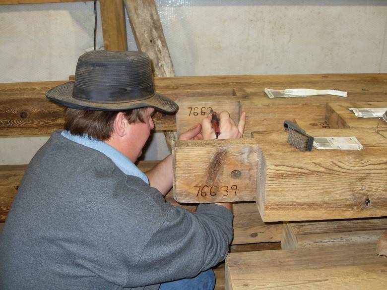 Camp Barn Restoration / Cannon Salvage workers cleaning, applying borate, and waxing the frame.